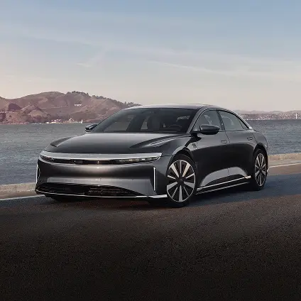 A Lucid Air Pure driving down the coast.